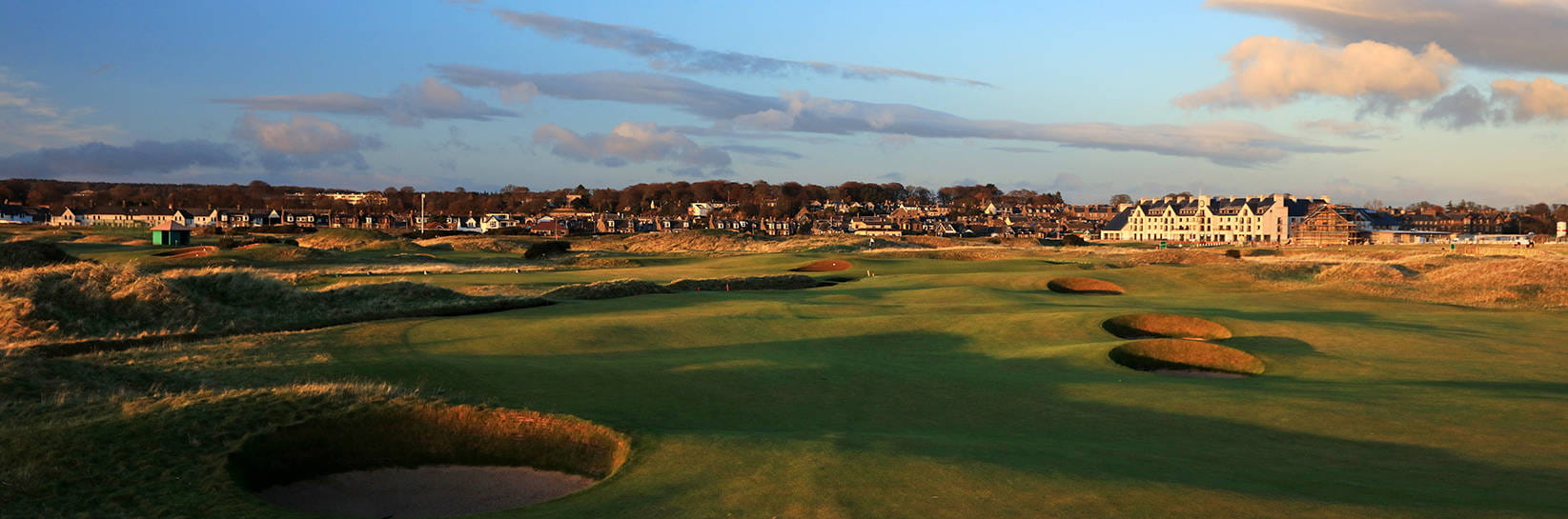 Beauty wide shot of Carnoustie golf club and the town at sunset